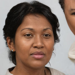 Joyful asian adult female with medium  brown hair and brown eyes