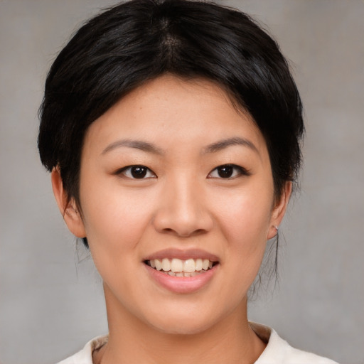 Joyful asian young-adult female with medium  black hair and brown eyes