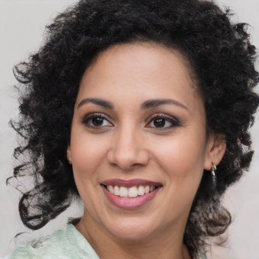 Joyful black young-adult female with medium  black hair and brown eyes