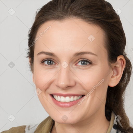 Joyful white young-adult female with medium  brown hair and grey eyes