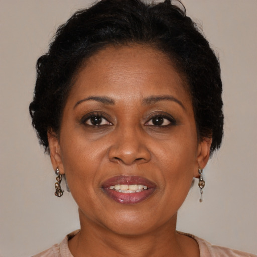 Joyful black adult female with medium  brown hair and brown eyes