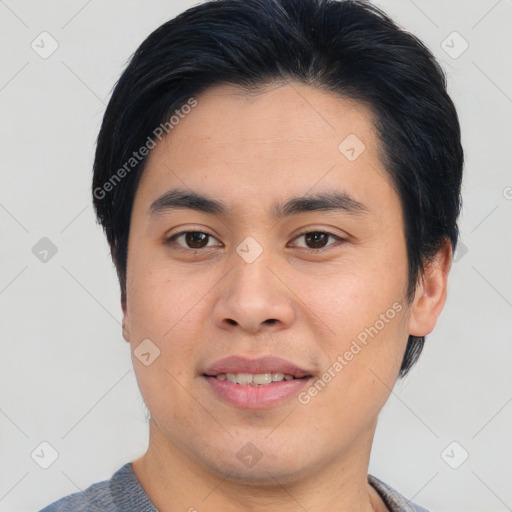 Joyful asian young-adult male with short  brown hair and brown eyes