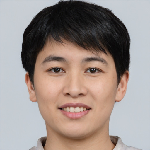 Joyful asian young-adult male with short  black hair and brown eyes
