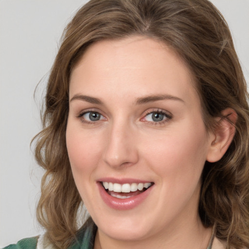 Joyful white young-adult female with medium  brown hair and green eyes