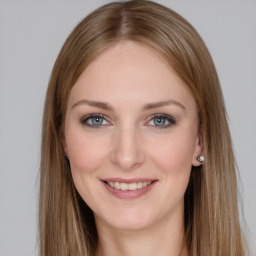 Joyful white young-adult female with long  brown hair and grey eyes