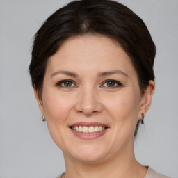 Joyful white adult female with short  brown hair and brown eyes