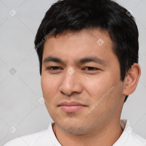 Joyful white young-adult male with short  black hair and brown eyes