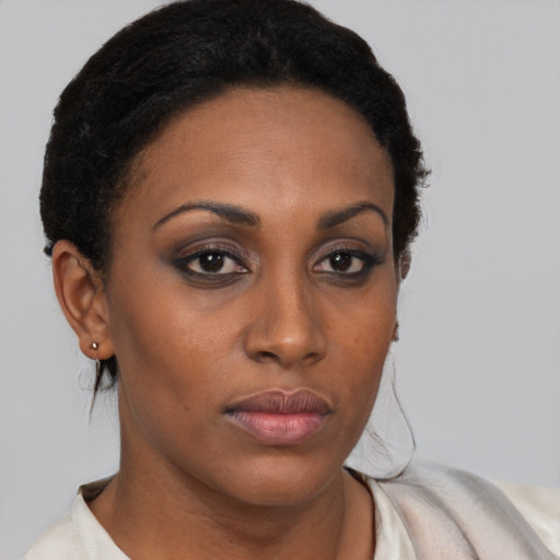 Neutral black young-adult female with medium  brown hair and brown eyes