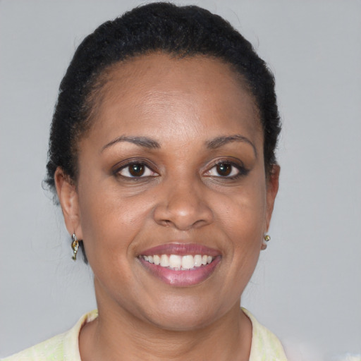 Joyful black adult female with short  brown hair and brown eyes