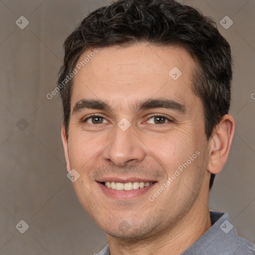 Joyful white adult male with short  brown hair and brown eyes