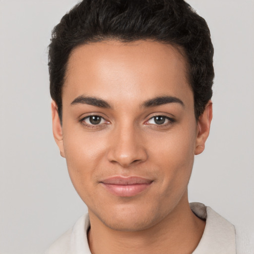 Joyful latino young-adult female with short  black hair and brown eyes