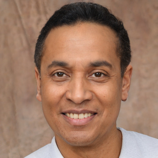 Joyful latino adult male with short  black hair and brown eyes