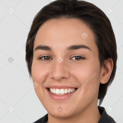 Joyful white young-adult female with short  brown hair and brown eyes