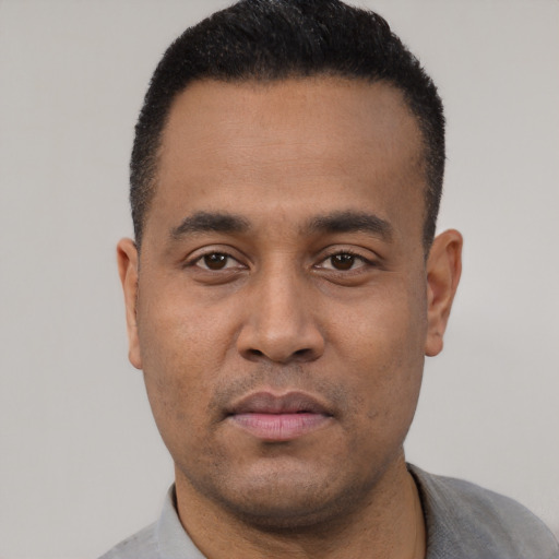 Neutral latino young-adult male with short  black hair and brown eyes