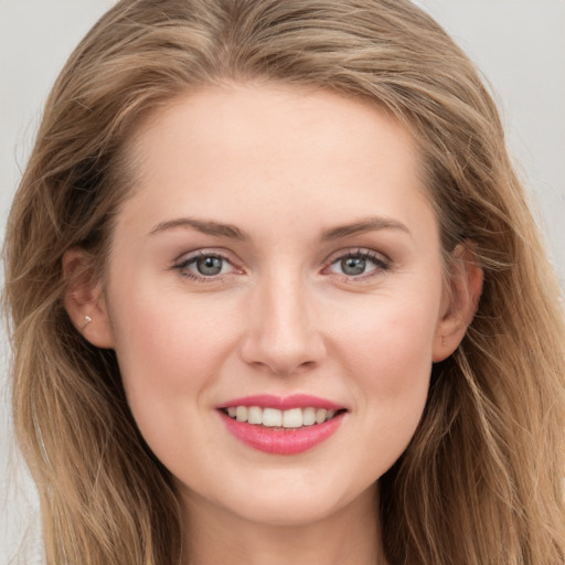 Joyful white young-adult female with long  brown hair and blue eyes