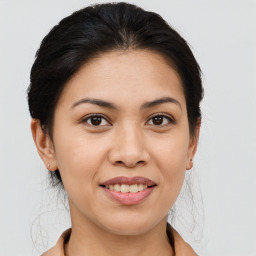 Joyful asian young-adult female with medium  brown hair and brown eyes