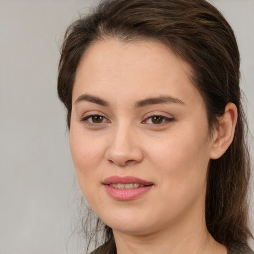 Joyful white young-adult female with medium  brown hair and brown eyes