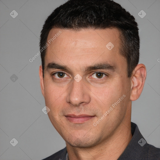 Joyful white young-adult male with short  black hair and brown eyes