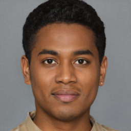 Joyful black young-adult male with short  black hair and brown eyes