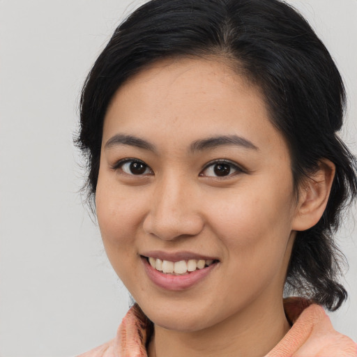 Joyful latino young-adult female with medium  black hair and brown eyes