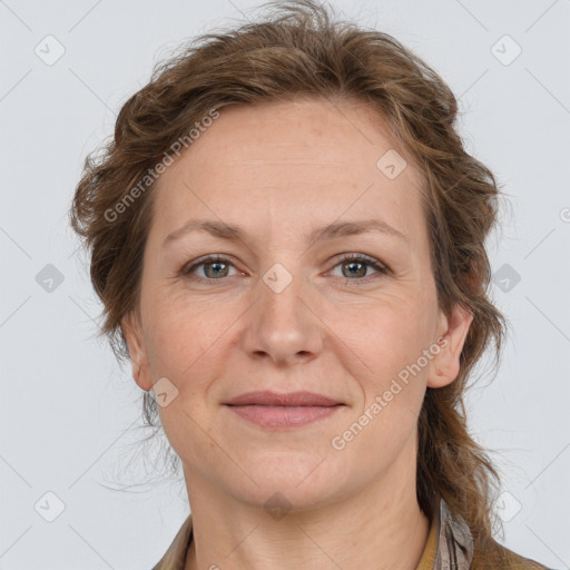 Joyful white adult female with medium  brown hair and grey eyes