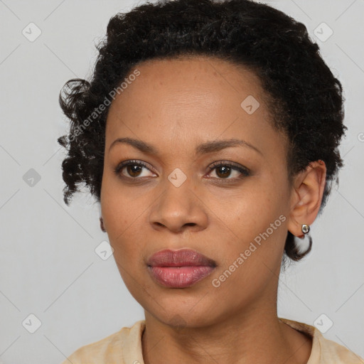 Joyful black adult female with short  black hair and brown eyes