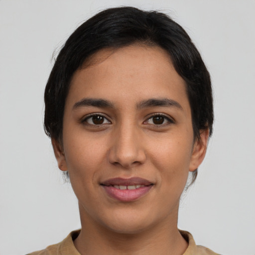 Joyful latino young-adult female with short  brown hair and brown eyes
