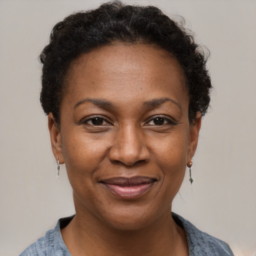 Joyful black adult female with short  brown hair and brown eyes