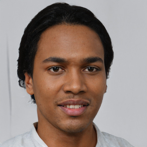Joyful black young-adult male with short  black hair and brown eyes