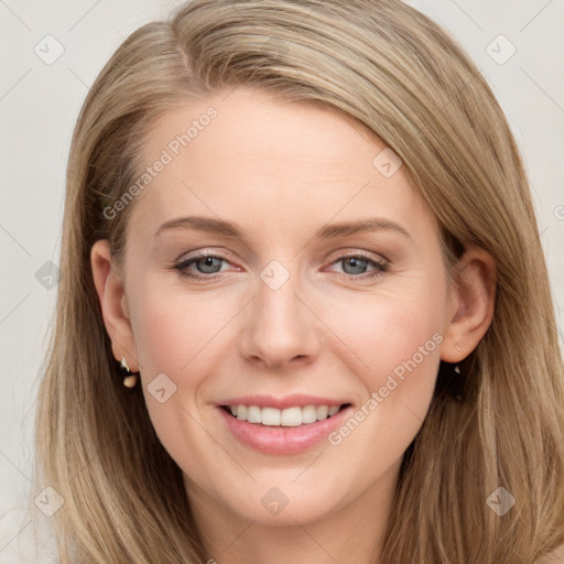 Joyful white young-adult female with long  brown hair and blue eyes