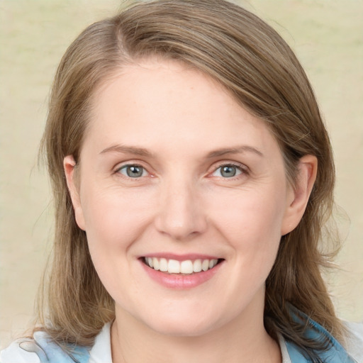 Joyful white young-adult female with medium  brown hair and blue eyes