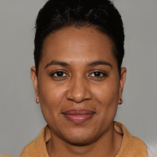 Joyful black young-adult female with short  brown hair and brown eyes