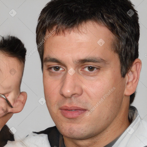 Joyful white adult male with short  brown hair and brown eyes