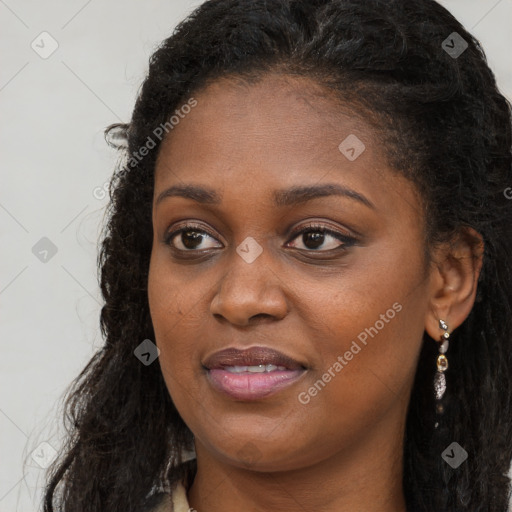 Joyful black young-adult female with long  brown hair and brown eyes