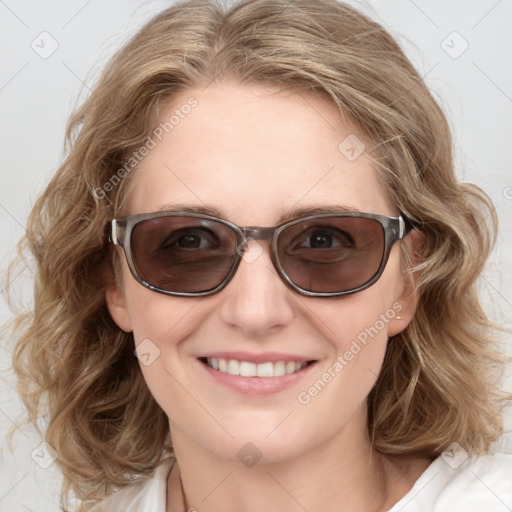 Joyful white young-adult female with medium  brown hair and blue eyes