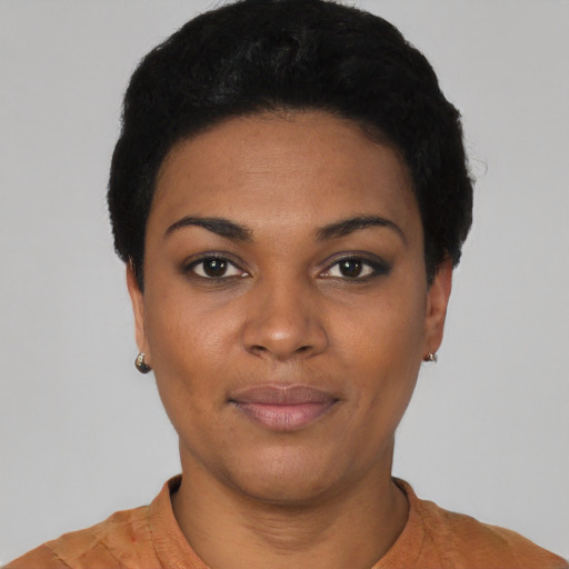 Joyful black young-adult female with short  black hair and brown eyes
