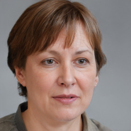 Joyful white adult female with medium  brown hair and grey eyes