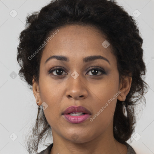 Joyful black young-adult female with long  brown hair and brown eyes