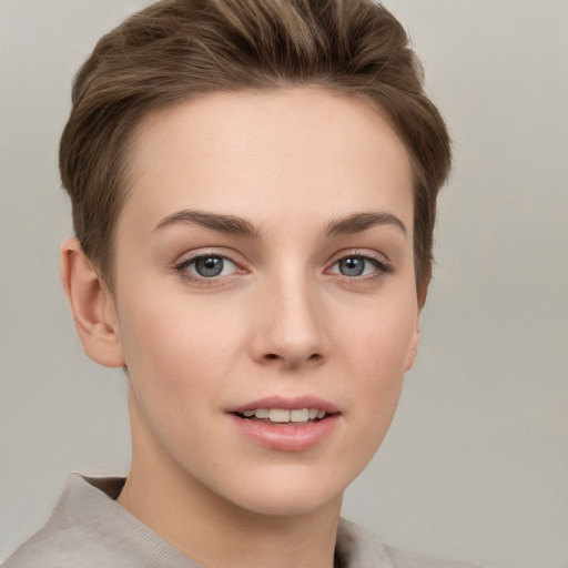 Joyful white young-adult female with short  brown hair and grey eyes