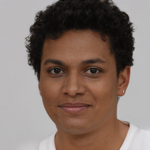 Joyful black young-adult male with short  brown hair and brown eyes