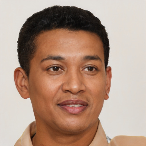 Joyful latino young-adult male with short  brown hair and brown eyes