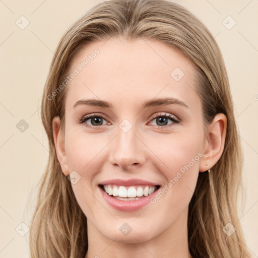 Joyful white young-adult female with long  brown hair and blue eyes