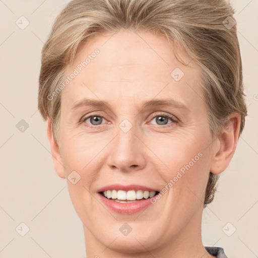 Joyful white adult female with short  brown hair and grey eyes