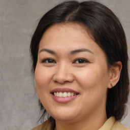 Joyful asian adult female with medium  brown hair and brown eyes