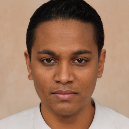 Joyful black young-adult male with short  black hair and brown eyes