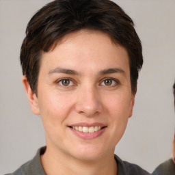Joyful white young-adult female with short  brown hair and brown eyes