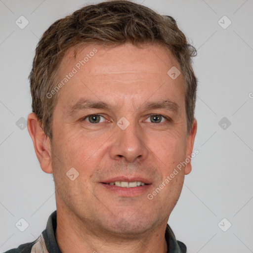 Joyful white adult male with short  brown hair and grey eyes