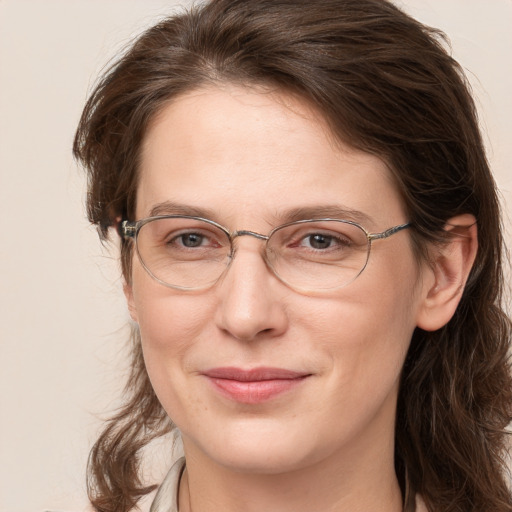 Joyful white adult female with medium  brown hair and grey eyes