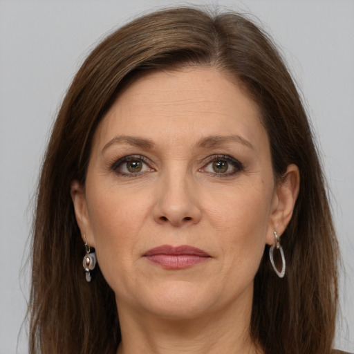 Joyful white adult female with long  brown hair and grey eyes