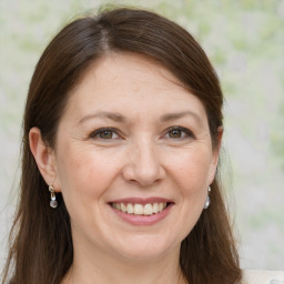 Joyful white adult female with medium  brown hair and brown eyes